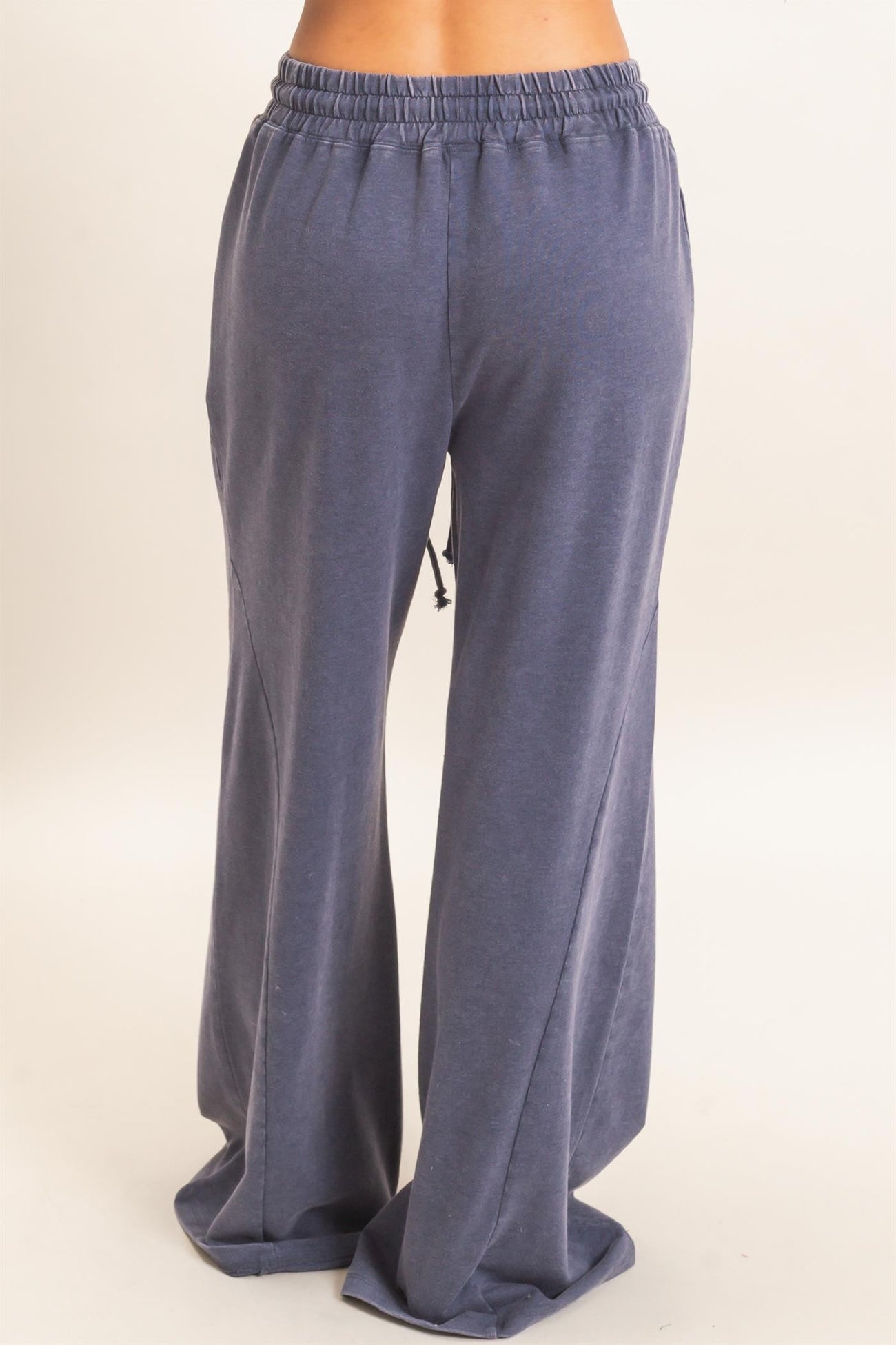 woman wearing navy blue relaxed fit wide leg jogger pants with an elastic waistband and drawstring detail