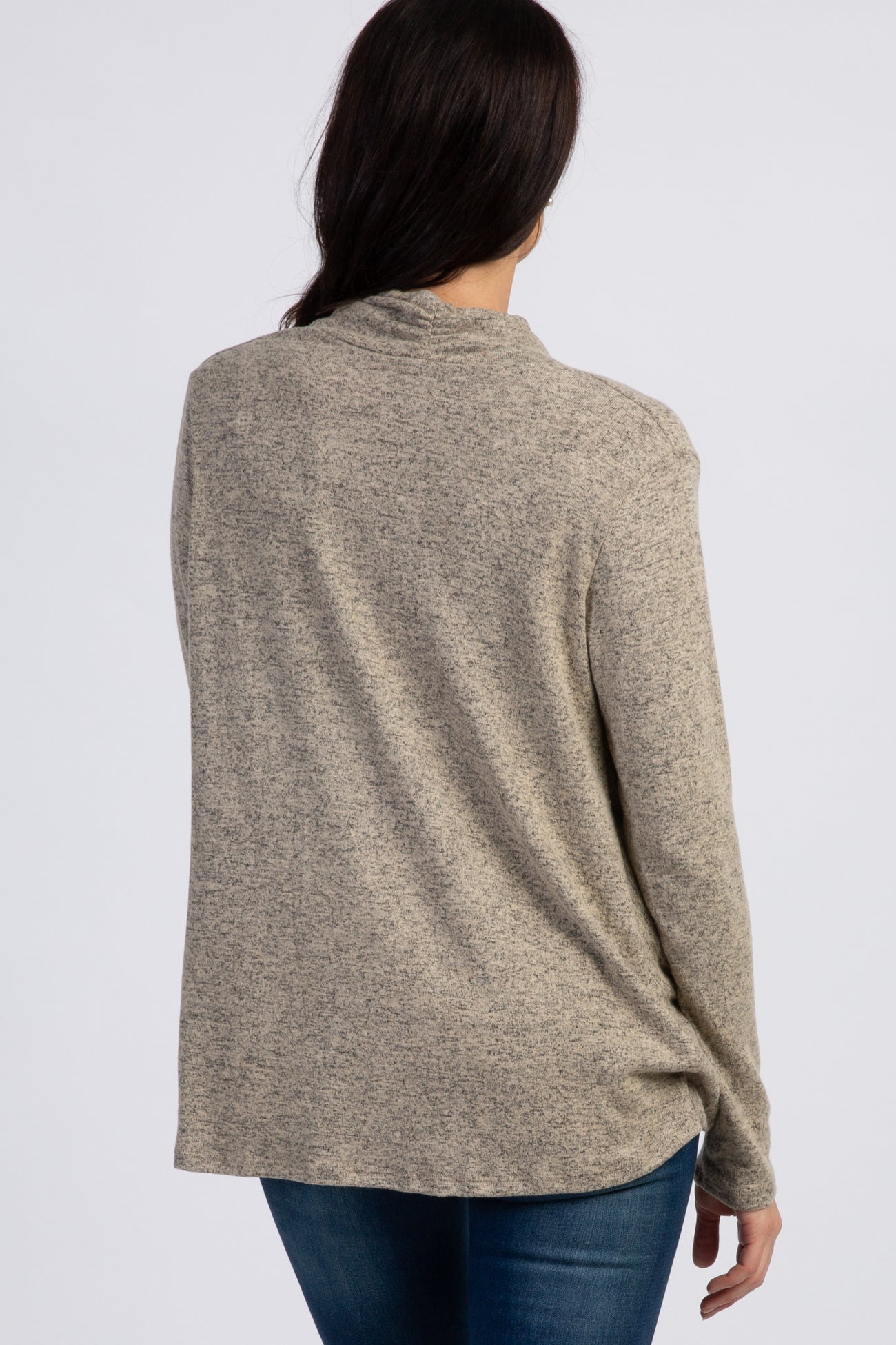 woman wearing a beige marled long sleeve sweater, showing the back view with relaxed fit and soft fabric