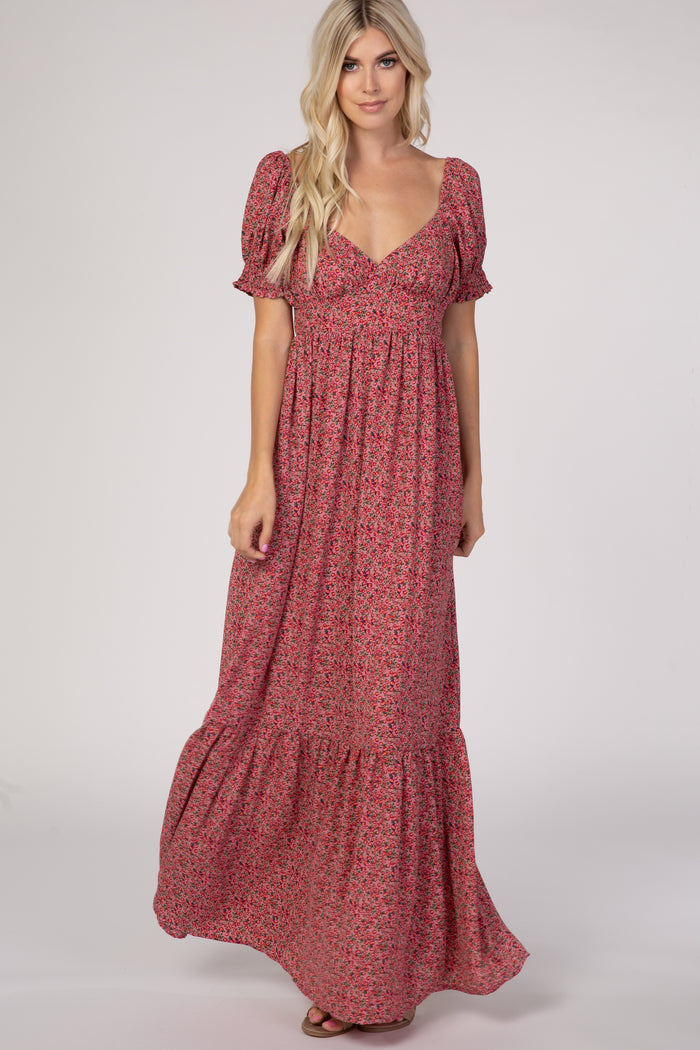 woman wearing a red floral long maxi dress with puff sleeves and a tiered skirt