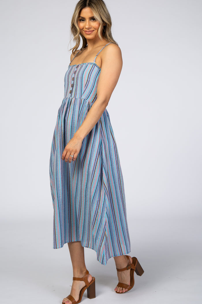 woman wearing a blue striped midi dress with buttons and spaghetti straps, standing in a side pose