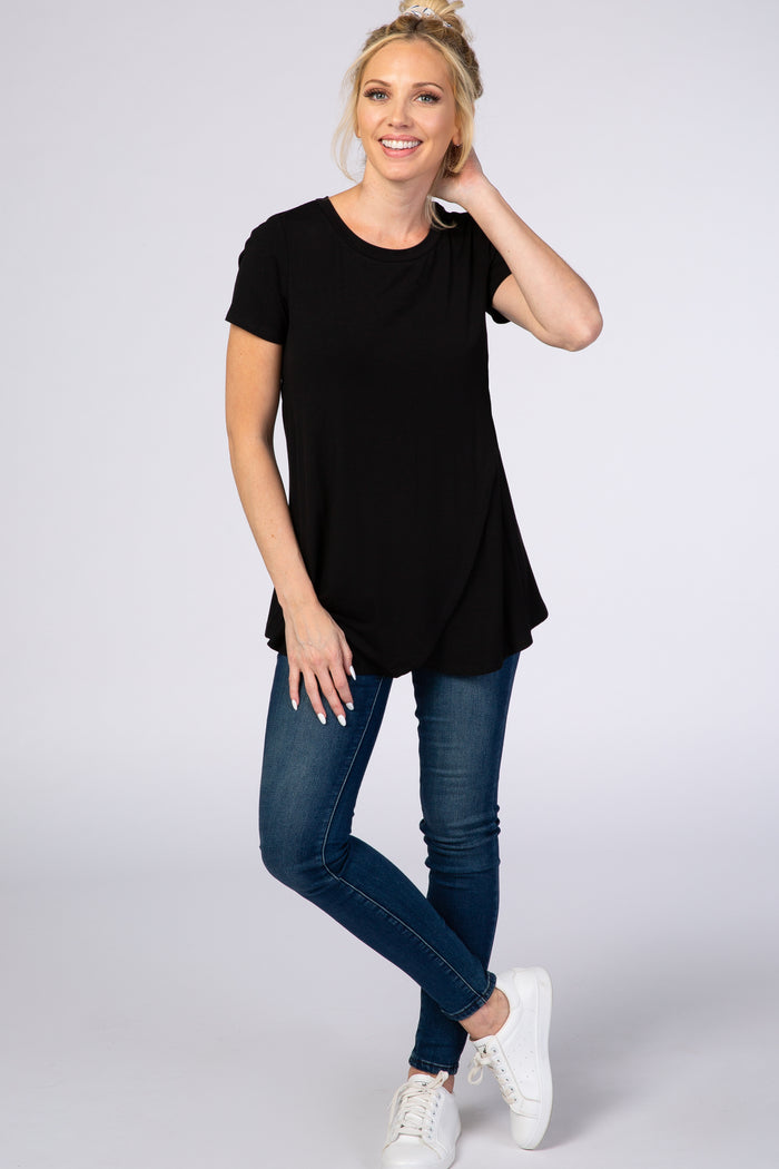 woman wearing a black short sleeve top paired with blue skinny jeans and white sneakers