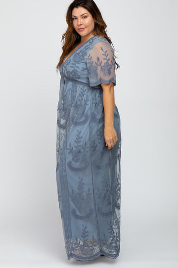 woman wearing a long blue sheer plus-size dress with floral embroidery and short sleeves