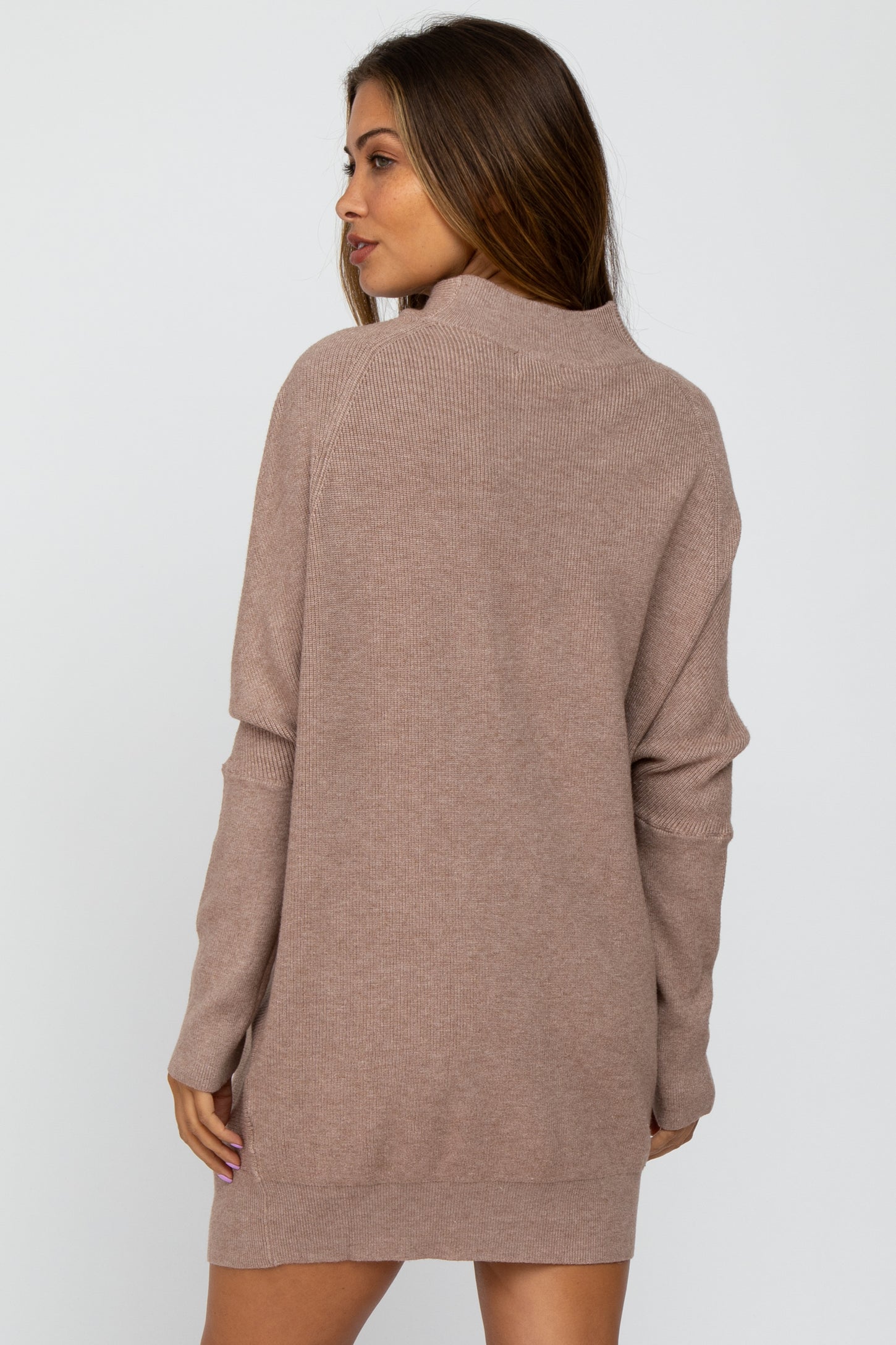 woman wearing a taupe maternity sweater dress with long sleeves and a relaxed fit from the back
