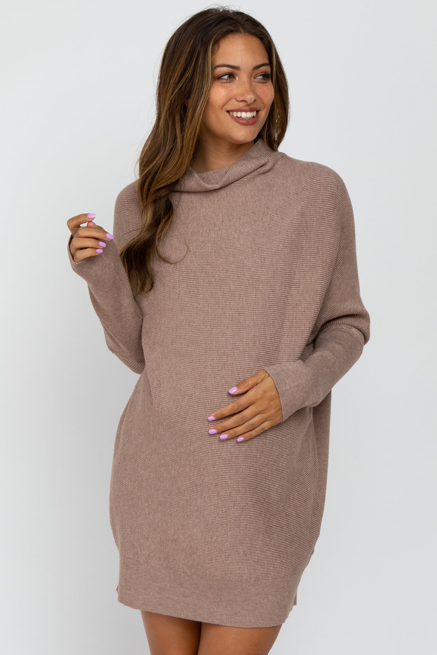 woman wearing a taupe cowl neck maternity sweater dress with a visible baby bump