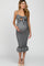 woman wearing a black and white striped maternity dress with a tie front, showcasing her baby bump and featuring a ruffled hem