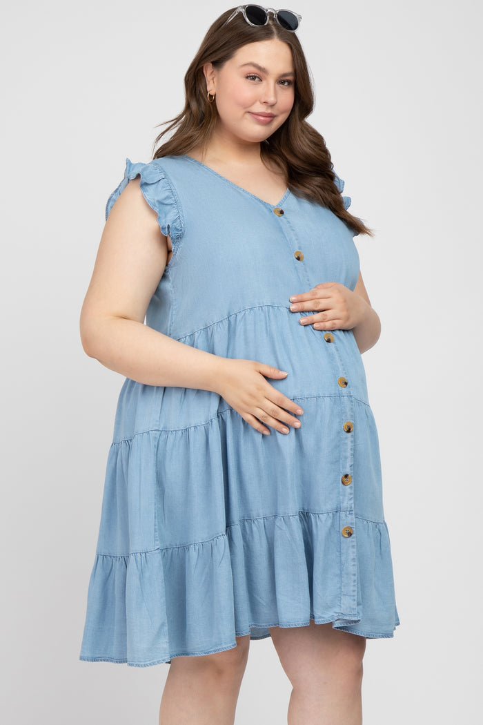 woman wearing a light blue tiered maternity dress with ruffle sleeves and buttons, showing her baby bump