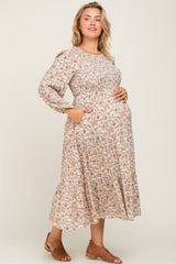 woman wearing a floral long sleeve maternity dress with pockets and showing her baby bump