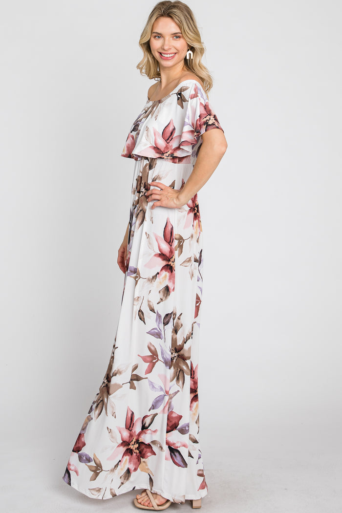woman wearing a white floral maxi dress with an off-the-shoulder design and ruffled details