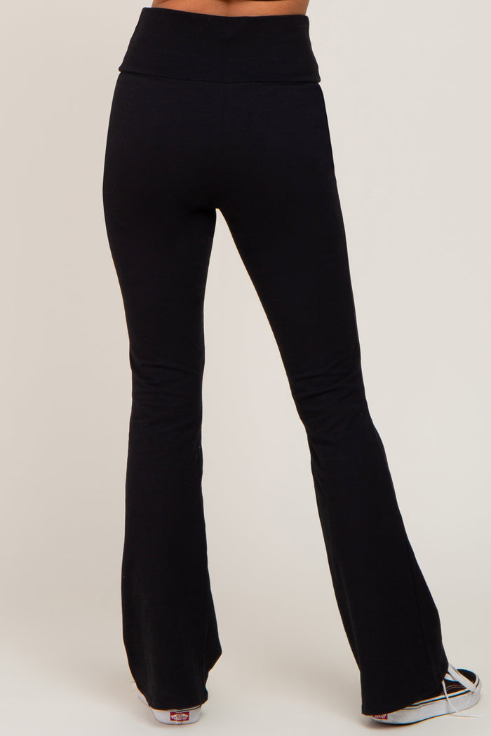 woman wearing black flared yoga pants, showing the back view