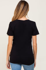 Back view of a woman with long blonde hair wearing a plain black short sleeve t-shirt and blue jeans
