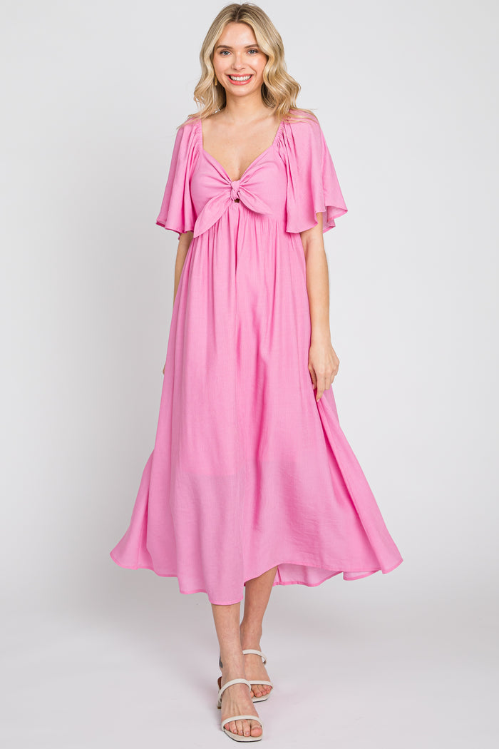 woman wearing a pink midi dress with flutter sleeves and a tied front detail