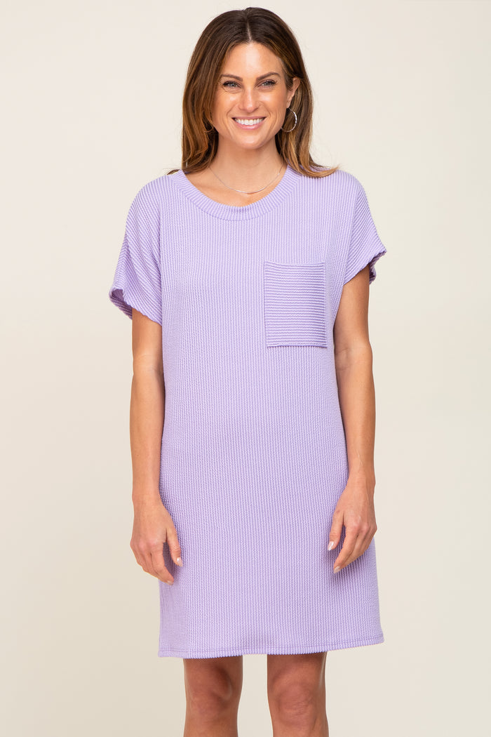 woman wearing a purple short sleeve ribbed dress with a front pocket