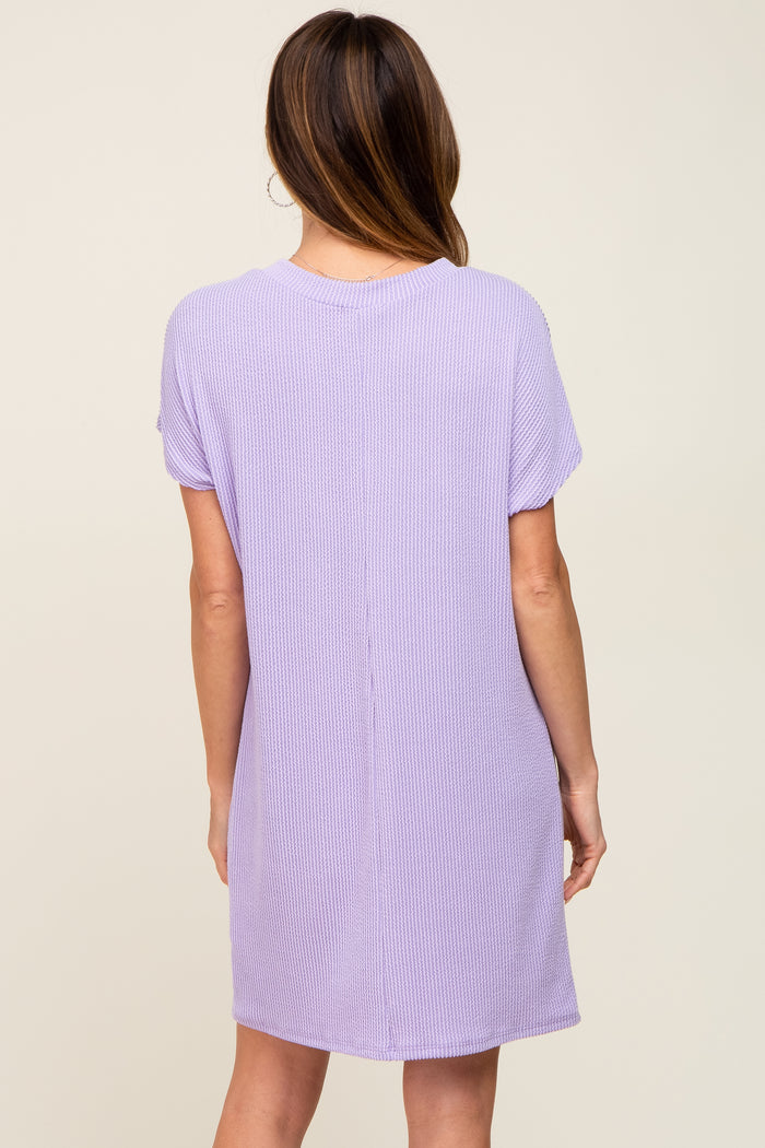 back view of a woman wearing a lavender short sleeve waffle knit shift dress