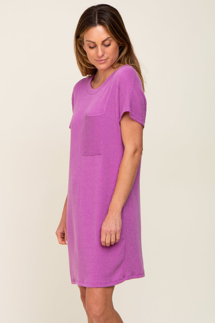 woman wearing a short sleeve ribbed pink dress with a pocket on the chest