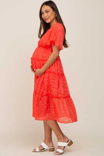 pregnant woman in red leopard print tiered maternity dress and white sandals