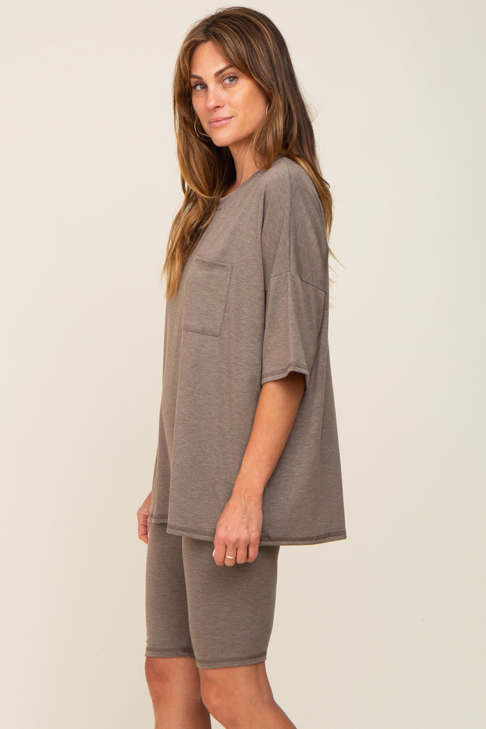 woman wearing a taupe oversized t-shirt with pocket and matching bike shorts