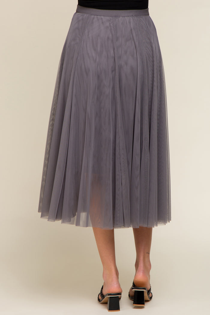 woman wearing a grey pleated tulle maternity skirt, shown from the back