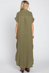 woman wearing an olive green maxi dress with short sleeves and a flowy back design