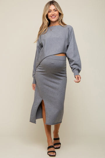 woman wearing a gray maternity two-piece set with a cropped top and a midi skirt featuring a side slit and a visible baby bump