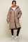 woman wearing a beige quilted puffer coat with a hood and zip closure, paired with black leggings and sneakers