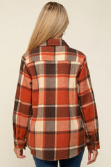 woman wearing a red, brown, and cream plaid maternity flannel shirt, shown from the back
