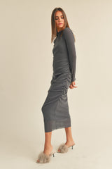 woman wearing a charcoal gray long sleeve ruched midi dress and stylish fuzzy slip-on heels