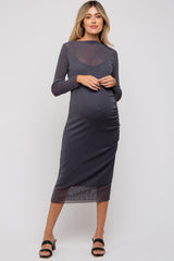 woman wearing a grey long sleeve maternity dress with ruching and a visible baby bump