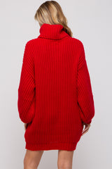 woman wearing a red oversized ribbed maternity sweater with a turtleneck and long sleeves, showing a relaxed fit