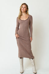 woman wearing a long sleeve ribbed midi dress in brown and beige stripes with knee-high white boots