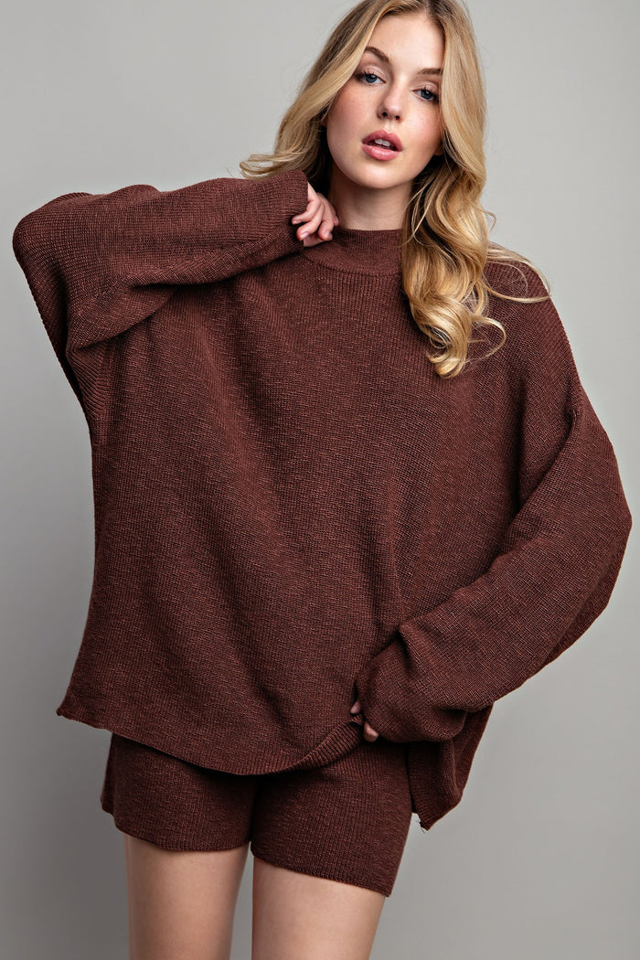 woman wearing a brown oversized knit sweater with matching shorts