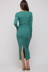 woman wearing a green long sleeve ribbed maternity dress with a back slit