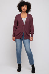 woman wearing a burgundy knit cardigan with buttons, paired with a gray top and blue jeans