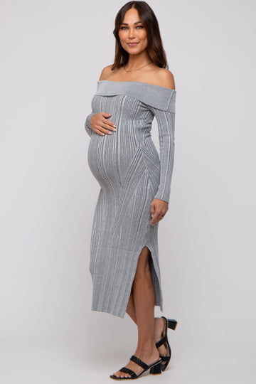 woman wearing a gray off-shoulder maternity dress with ribbed detail and side slits, showcasing her baby bump