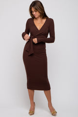 woman wearing a brown wrap midi dress with long sleeves and a tie detail at the waist