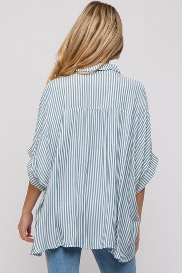 woman wearing a striped maternity shirt with a loose fit and rolled sleeves, viewed from the back