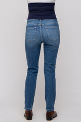 maternity wear blue skinny jeans with a dark blue over-the-belly waistband, shown from the back