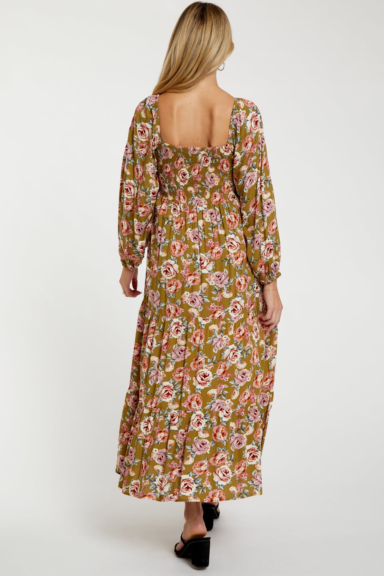 woman wearing a floral print maternity maxi dress with long sleeves and a square back style