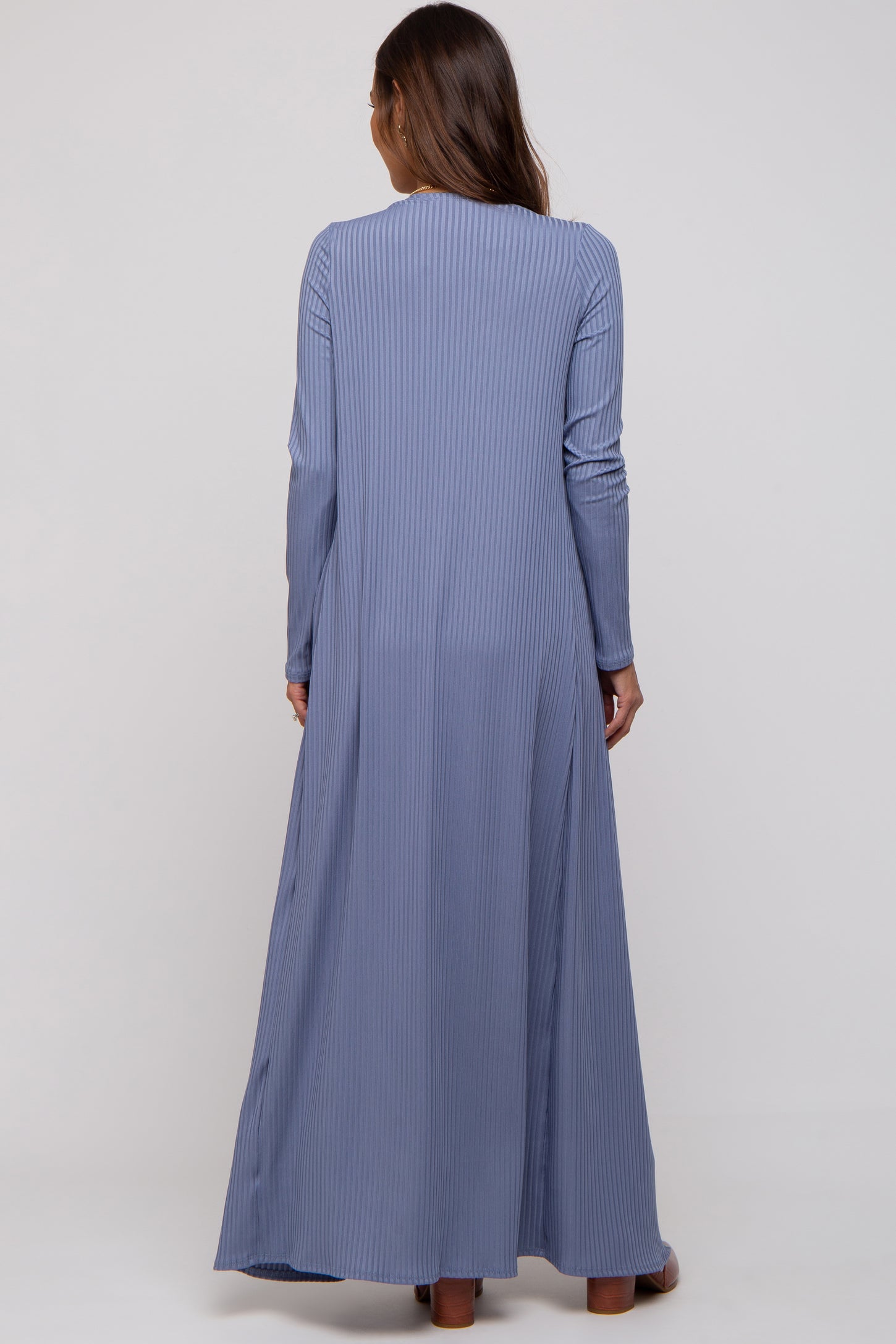 woman wearing a long sleeve blue striped maternity dress, seen from the back