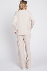 woman wearing a beige ribbed knit long sleeve top and matching wide-leg pants, view from the back