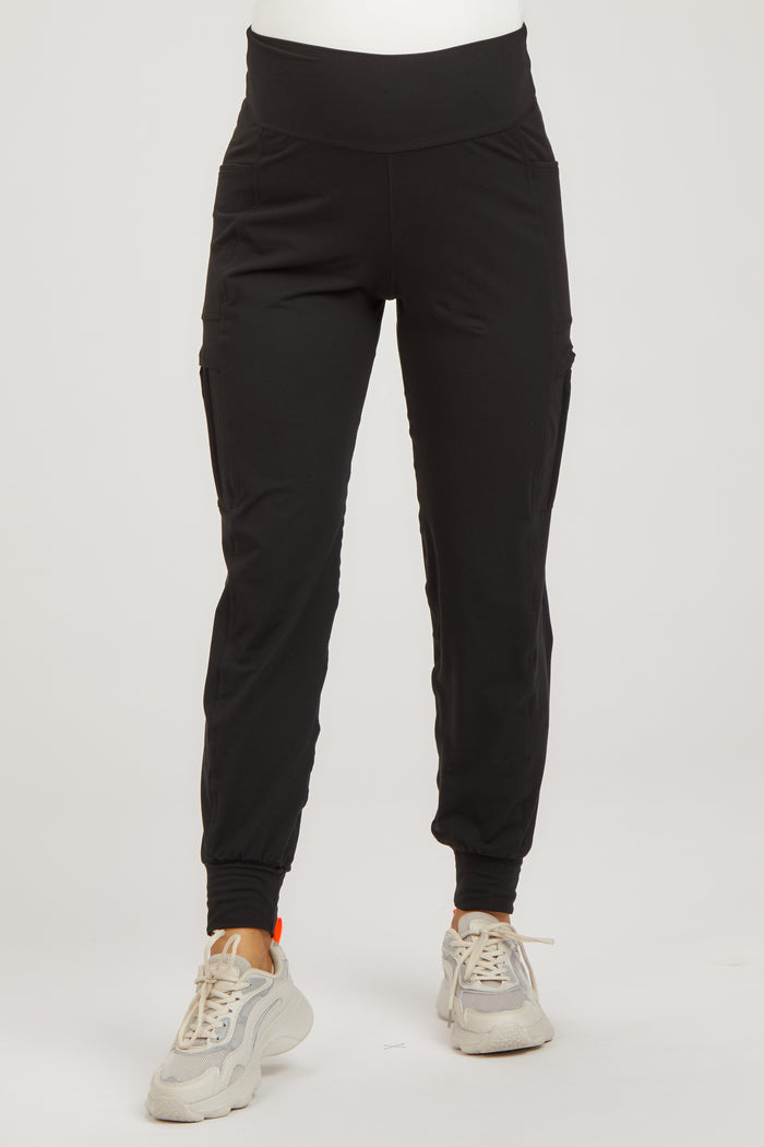 woman wearing black maternity jogger pants with side pockets and a stretchy waistband