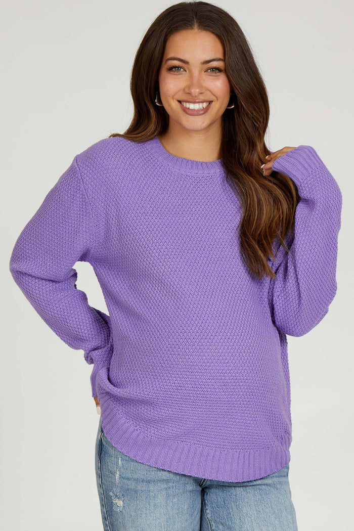 woman wearing a lavender knit maternity sweater with a relaxed fit and long sleeves