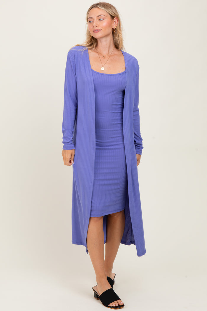 woman wearing a purple ribbed maxi cardigan over a matching fitted dress and black slide sandals