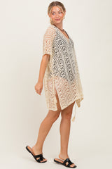 woman wearing a cream ombre lace cover-up dress with a v-neck and side slits, paired with black sandals