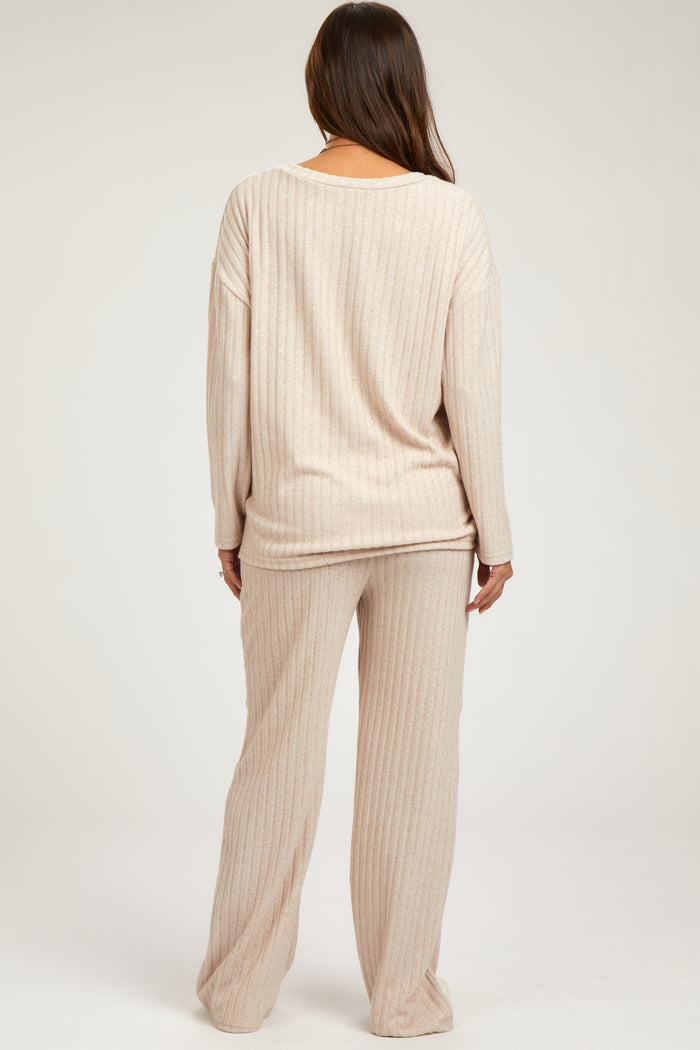 woman wearing a light beige long sleeve maternity top and matching pants, showcasing a relaxed fit and ribbed texture