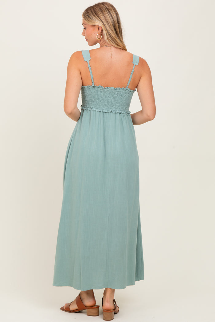 woman wearing a light teal maxi dress with smocked bodice and adjustable straps, seen from the back