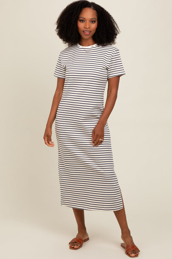 woman wearing a white and black striped t-shirt midi dress with short sleeves and side slits