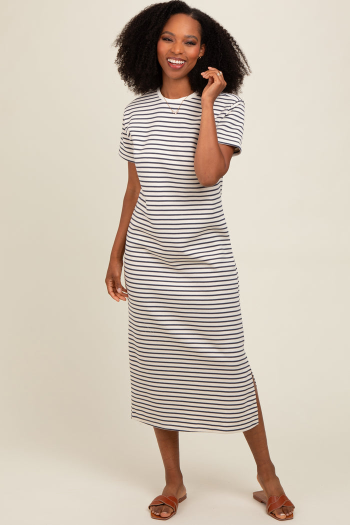 woman wearing a short sleeve striped midi dress with a relaxed fit and side slits