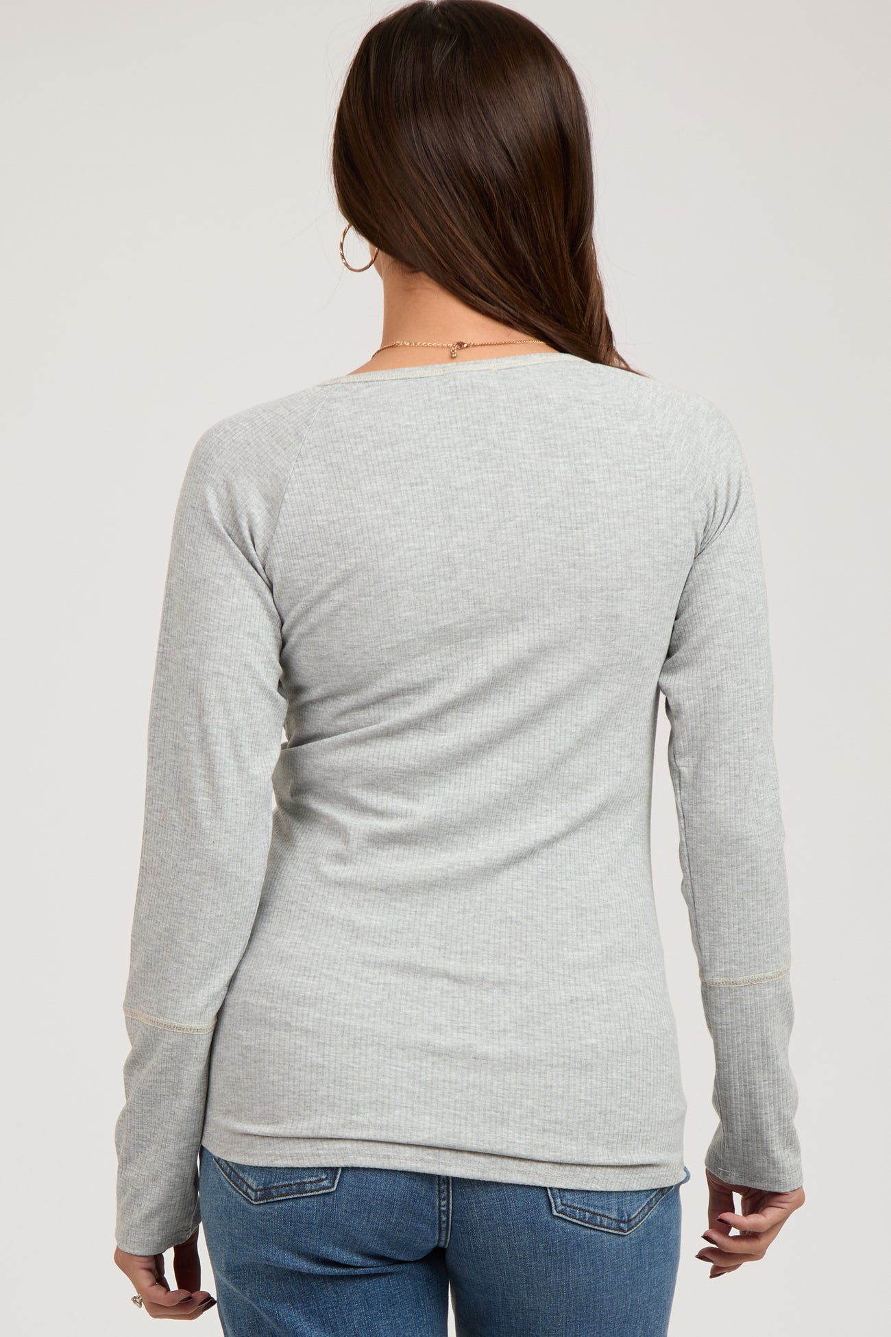 woman wearing a light gray ribbed maternity long sleeve top, seen from the back with a relaxed fit
