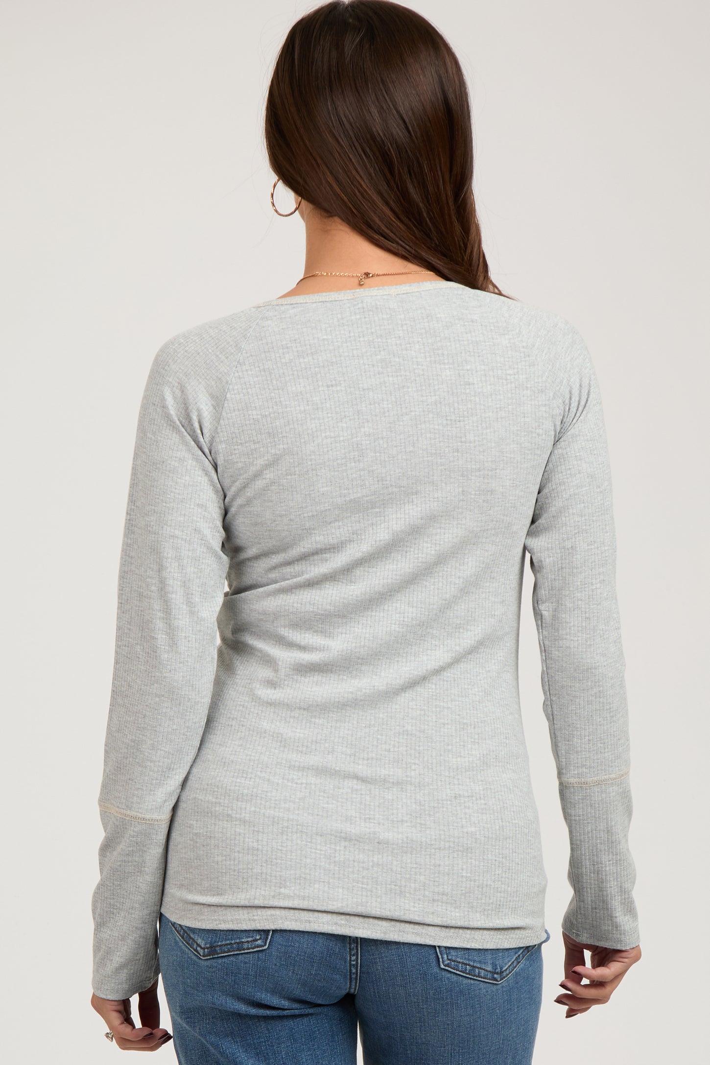 woman wearing a light gray ribbed maternity long sleeve top, seen from the back with a relaxed fit