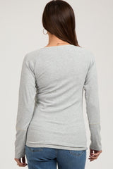 woman wearing a light gray ribbed maternity long sleeve top, seen from the back with a relaxed fit